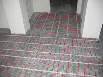ComfortTile floor heating cable being installed.