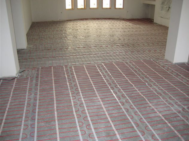Radiant floor heating cable being installed for a heated floor.